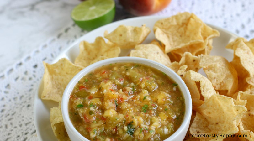 Delicious fresh peach salsa recipe prepared and served with tortilla chips.