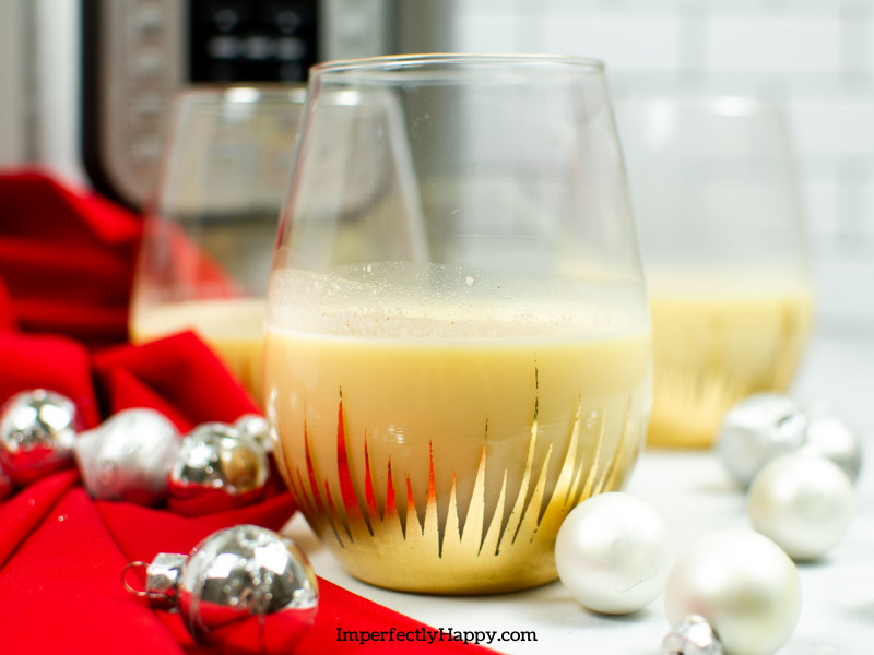 Instant Eggnog with Instant pot in the background and glasses of eggnog on Christmas table setting.