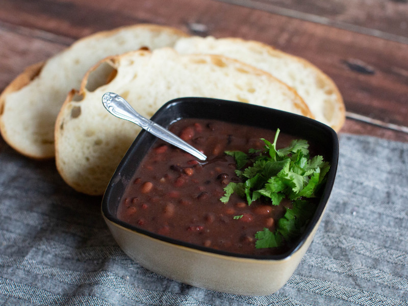Dry Bean Soup Mix Recipe prepared with cilantro garnish and bread.